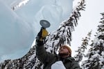Nicolas Graham smooths out an ice sculpture with a sander in Fairbanks, Alaska.