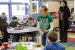 Teacher Laurie Shonkwiler passes out material for a water filtration experiment at Bridger K-8 in southeast Portland.