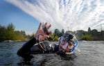Lled Smith of Loot the Deschutes surfaces at the Bend Whitewater Park with two pairs of sunglasses on Aug. 9, 2023.  Not all his finds are benign: he was once shocked by an electrified underwater cable. He's also found guns, knives and lots and lots of fish hooks.