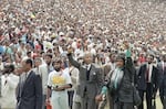 FILE Nelson Mandela and Winnie Mandela give Black power salutes as they enter Soweto's Soccer City stadium, South Africa Tuesday, Feb. 13, 1990. 120,000 thousand people packed the venue to hear his speech.
