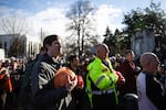 Joe Schaefer (left with orange hat) from Scio listens to the national anthem at a Timber Unity rally in front of the Oregon Capitol in Salem, Ore., Thursday, Feb. 6, 2020.