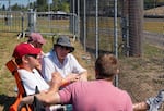 Kalvin Hargrave, Connor Smith, Ron Smith and Trisha Smith watch IndyCars fly down the long back straight going into turn 10.