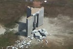 Rubble is cast around the Georgia Guidestones after an explosion in Elberton, Georgia, U.S., July 6, 2022 in a still image from video.