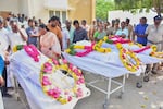 Relatives of people who were killed in a stampede during a rally for a popular Indian actor and politician, mourn as they take the bodies from a hospital, in Karur, in the southern state of Tamil Nadu, Sunday, Sept. 28, 2025.