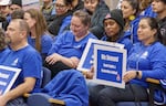 FILE - Portland Association of Teachers members and supporters hold signs as they attend a board meeting at the Portland Public Schools district office in Portland, Nov. 7, 2023.