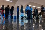 Federal workers, including Transportation Security Administration officers and air-traffic controllers, lined up last week to receive food parcels at Newark Liberty International Airport in New Jersey during the government shutdown. Attendees each received a box of nonperishable items, one premium 10-pound produce box, along with potatoes, spaghetti squash, and apples.
