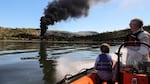 Chris Hooper, right, of White Salmon watches the fire caused by a derailed oil train in Mosier, Oregon, near Hood River in the Columbia River Gorge on Friday, June 3, 2016.