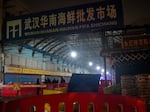 Security guards stand in front of the Huanan Seafood Wholesale Market in Wuhan, China, on Jan. 11, 2020, after the market had been closed following an outbreak of COVID-19 there. Two studies document samples of SARS-CoV-2 from stalls where live animals were sold.