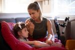 Jenny Eckart Hoyt directs her daughter Winnie's attention to an "eye gaze" device in their Portland, Ore., home. The communication skills the eye gaze can unlock are critical for Winnie's educational future. To master it, Winnie needs a lot of practice with a trained instructor.