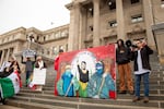 Eddie Melendrez, a Chicano artist, speaks in a megaphone while showcasing his mural representing the United Farmworkers of America, a labor union that advocates for farmworker rights. Melendrez, and nearly 100 others, protested President Donald Trump’s immigration policies in front of the Idaho State Capitol in Boise on Feb. 7, 2025.