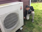 Peter Kernan of Enhabit checks the efficiency of a heat pump system.