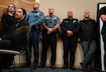 Law enforcement officers stand by during a press conference at Bend Municipal Court after an Oct. 15 mass shooting at Silver Rail Elementary School. 