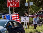 Pro-ICE supporters hold signs near the U.S. Immigration and Customs Enforcement building in South Portland, where U.S. Department of Homeland Security Secretary Kristi Noem is visiting, October 7, 2025.