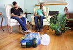 Ed and Sara Johnson sit with what remains of their water and propane supply. They say that over the course of the weekend they learned how to be more efficient with both. 