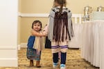 Akane Ironheart, 18 months, citizen of the Sauk-Suiattle tribal nation, and two other young girls wear wool shawls woven by her mother, Stephanie Ironheart, an enrolled member of the Cheyenne and Arapaho Tribes of Oklahoma.