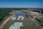 Barges were stranded by low water levels along the Mississippi River in October, driving up shipping prices and threatening crop exports and fertilizer shipments. Scientists at the University of Memphis expect more dramatic swings in water levels on the river due to climate change.