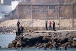 Migrants try to cross into the Spanish enclave of Ceuta from Morocco, Thursday, July 30, 2026.