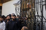 FILE -Atef Najib, former head of the Political Security Branch in the Daraa area during Bashar Assad's rule, sits in the defendants' cage during a trial session at the Palace of Justice in Damascus, Syria, April 26, 2026.