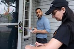 Hillsboro City Council candidates Karim Delgado, left, and Dorian Russell, right, talk while canvassing on Saturday, Sept. 12, 2026.