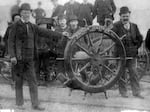 This undated image shows men posing with the recovered wheel from the lost ship, the S.S. Brother Jonathan, which wrecked off the coast of Crescent City, CA, in 1865.