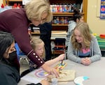 Class of 2025 student Kaylie, right, plays with Paige, a preschooler, center, at David Douglas High School. Kaylie is part of a career technical education program focused on early childhood education, which involves planning lessons for a preschool class.