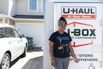 ShaWayne Hodges stands in front of a shipping container while preparing to move to Georgia from her Vancouver, Wash., home on Wednesday, July 31, 2024. (Amanda Loman/InvestigateWest)