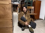 Chrissy Shimizu, the Wing Luke Museum's Executive Director, sits on the floor of the basement inside the Wing Luke Museum. Shimizu said she spent a lot of time there when she fundraised for the museum from 2017 to 2021.