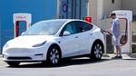 A Tesla owner charges his vehicle in April 2021 at a charging station in Topeka, Kan.. Tesla reported 273 crashes involving partially automated driving systems, according to statistics released by U.S. safety regulators on Wednesday.