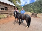 Ruby Ranch owner Kim Ibarra and equine specialist Laura Williams stand with Simon, a Welsh pony training to become a therapy horse.