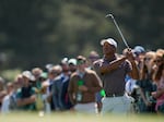 Tiger Woods watches his chip on the 18th hole Friday at the Masters tournament at Augusta National Golf Club in Augusta, Ga.