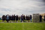 Men incarcerated at Two Rivers Correctional Institution wait to re-enter the prison following a community event Aug. 24, 2019, in Umatilla, Ore.