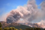 Smoke and flames rise as a wildfire advances near La Adrada, Ávila province, Spain, Friday, July 24, 2026.