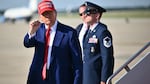 President Trump pumps his fist after stepping off Air Force One at Joint Base Andrews in Maryland on Saturday.