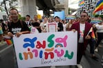Participants hold posters celebrating equality in marriage during the Pride Parade in Bangkok, Thailand, Saturday, June 1, 2024. Thailand is kicking off its celebration for the LGBTQ+ community's Pride Month with a parade on Saturday, as the country is on the course to become the first nation in Southeast Asia to legalize marriage equality.