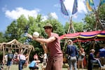 A man demonstrates his skills in sphere manipulation, otherwise known as contact juggling. Many flow artists share their toys and talents in Xavanadu.