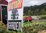 Activists with the environmental action group Extinction Rebellion, including Ken Ward, left, watch over a protest garden planted near the tracks of Zenith Energy's oil-by-rail terminal in Portland, Oregon, on Sunday, April 21, 2019.