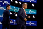 Donald Trump, on the right side of the frame, walks onstage after being introduced by Charlie Kirk, on the left side of the frame, at the Turning Point Action conference on July 15, 2023, in West Palm Beach, Florida.