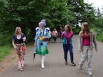 Efemmera Gendera talks with Amanda Giel, left, of Vancouver, WA during a Drag Me Outside drag nature hike at Mt. Tabor Park in Portland, Ore., on May 10, 2026.