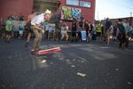 Bim Ditson sweeps the concrete after sandwiches are thrown around during a game of Rigsketball. The 32-band tournament continues throughout the weekend.