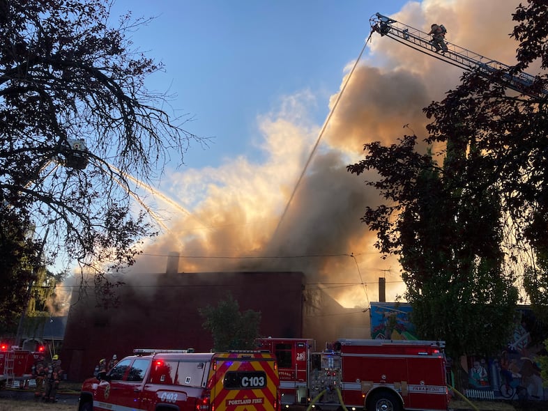 Firefighters from Portland Fire & Rescue battle flames at the historic Roseway Theater which suffered heavy damage from a fire on Aug. 6, 2022.