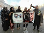 Pakistan Tehreek-e-Insaf party activists and supporters of former Prime Minister Imran Khan block a road during a protest against the arrest of their leader in Hyderabad, Pakistan, on Tuesday.