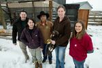 At left, Yakama Nation aviary biologists Michael Beckler and Alyssa Woodward pose for a photo with Yakama Nation Tribal Council member Terry Heemsah, center, as Washington State University wildlife veterinarian Dr. Marcie Logsdon holds a juvenile golden eagle rehabilitated at WSU’s College of Veterinary Medicine. To Logsdon's right is WSU veterinary technician Alexis Adams. Picture taken Jan. 25, 2024 before the eagle was released into the tribe's aviary.