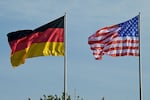 The German and the U.S. flags fly in front of the Chancellery in Berlin, on Oct. 18, 2024.