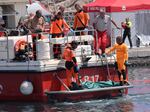 Italian firefighter divers bring ashore the body of one of the victims of a shipwreck, in Porticello, Sicily, on Friday Aug. 23.