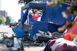 A person sleeps outside a tent at one of the most populated homeless camps near downtown Vancouver, where officials hope to soon begin shifting some people to designated safe communities with temporary shelters. The city is preparing the first such community at a cul-de-sac in Vancouver’s North Image neighborhood at 1140 NE 51st Circle.