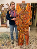 Betty LaDuke with "Almeda Fire, Agony and Resilience," in her Ashland studio.