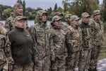 Members of the female anti-drone mobile air defence unit known as the "Bucha Witches," along with other members from the military volunteer formation of the Bucha territorial community, line up before their shift in Bucha, Kyiv region, Ukraine on Oct. 12, 2024.