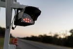 A license plate reader stands along the side of a road, Wednesday, Oct. 15, 2025, in Stockdale, Texas. (AP Photo/David Goldman)