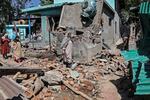 Soldiers in Indian-administered Kashmir blew up the family homes of two men suspected of carrying out Tuesday's deadly attack on tourists in Pahalgam. People walk through the debris of a demolished house related to the family of one of the suspects in southern Kashmir on Friday.