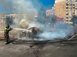 In this photo released by Belgorod regional governor Vyacheslav Gladkov's Telegram channel on Sunday, Sept. 1, 2024, firefighters extinguish a burning car in the courtyard of an apartment building after a missile attack by the Armed Forces of Ukraine on the city of Belgorod and the Belgorod region of Russia.
